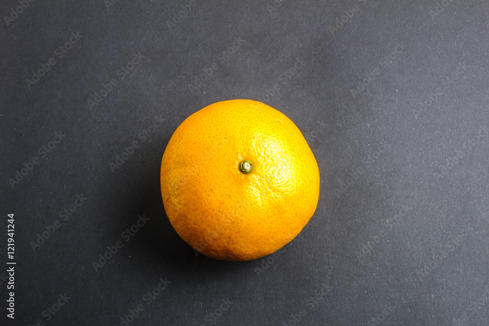 Orange mandarin or tangerine fruit on black background Orange mandarin or tangerine fruit on black background