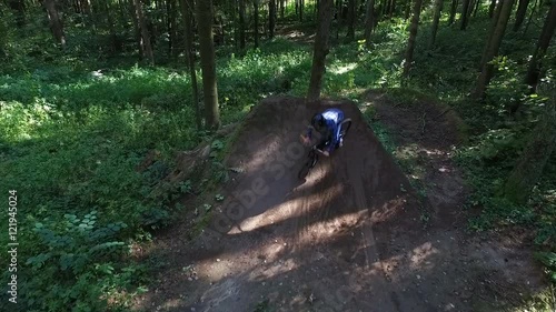 Aerial shot back view MTB BMX Bar Spin trick dirt jump photo