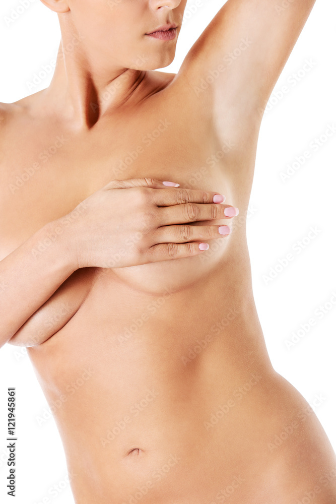 Topless woman covers her breasts with hands. Topless woman covers her breasts with hands.