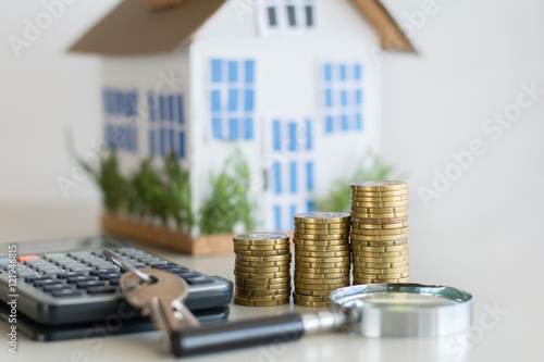 Mortgage concept focused on the coins and keys real estate property with loan money bank concept.