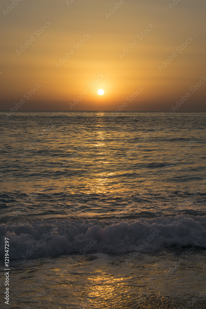 Romantic sunset on the sandy beach with blue sea waves 1