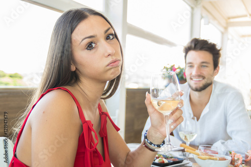 Young woman making an exasperated expression gesture on a bad date photo