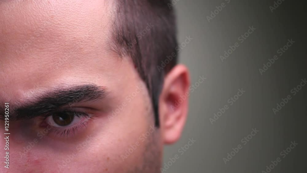 Half face of an angry man showing his anger. Half face of an angry man showing his anger.