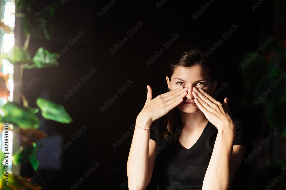 Beautiful young woman with hands on her face Beautiful young woman with hands on her face