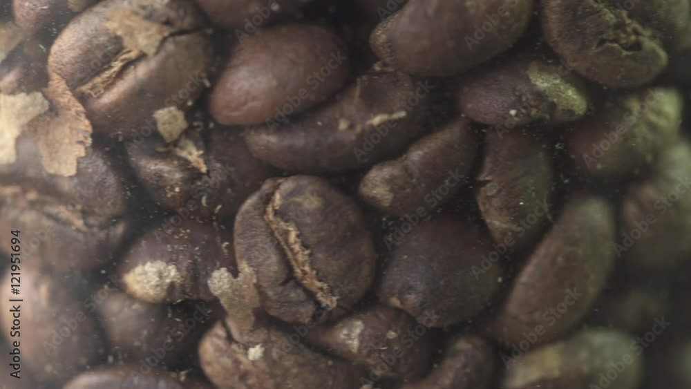 Coffee beans rotating in jar close up macro shot Coffee beans rotating in jar close up macro shot
