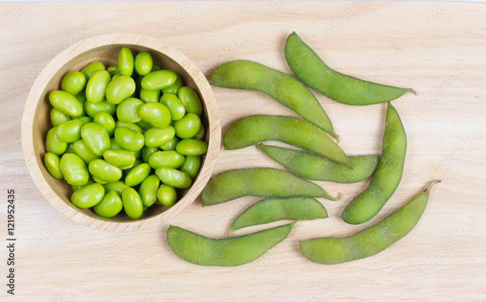 Green Japanese Soybeans in a wooden bowl on wooden background Green Japanese Soybeans in a wooden bowl on wooden background