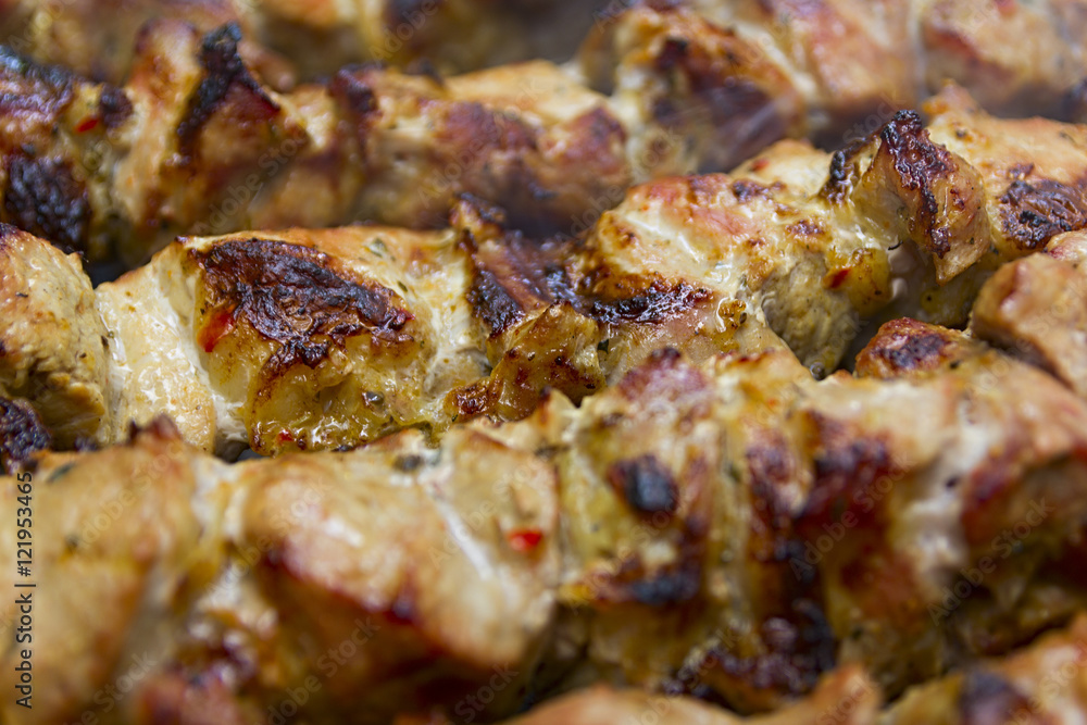 Hot shish kebab on metal skewers prepares on the coals outdoors. Hot shish kebab on metal skewers prepares on the coals outdoors.