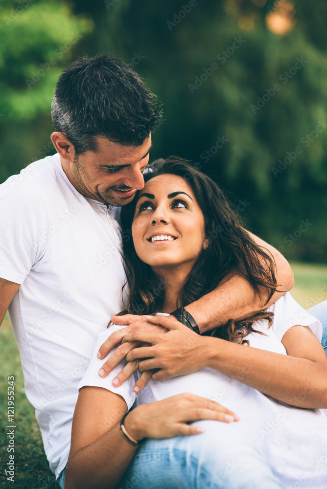 Young loving affectionate couple dating and enjoying their love at the park on summer or spring. Young loving affectionate couple dating and enjoying their love at the park on summer or spring.