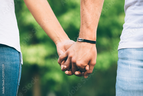 Detail of lovers clasped hands. Dating and love concept.