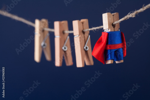 Canvas Print Powerful super hero conceptual photo with superstar clothespin character in blue suit red cape