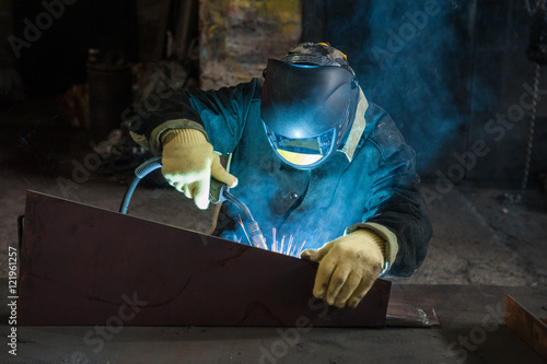 worker welding metal