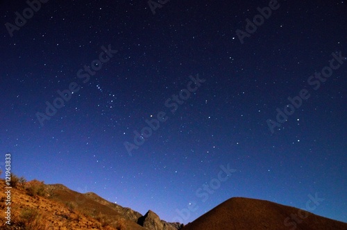 Stargazing in Elqui Valley with hundreds of stars in the sky between black hills in Chile, South America © mandy2110