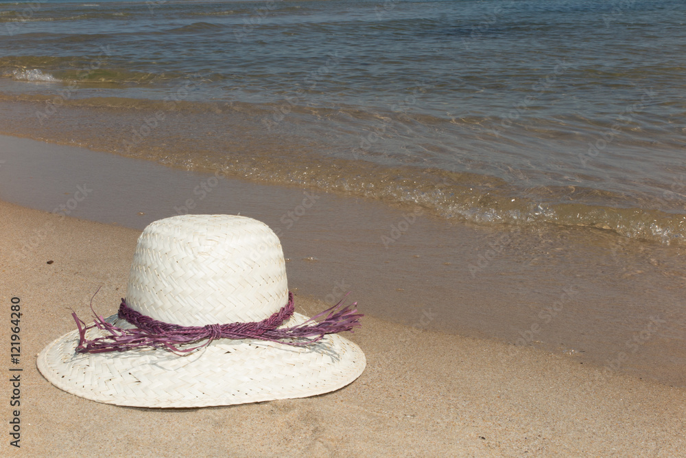Straw hat on a tropical beach summertime Straw hat on a tropical beach summertime