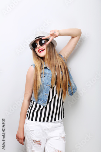 Portrait of a beautiful hipster girl on grey background