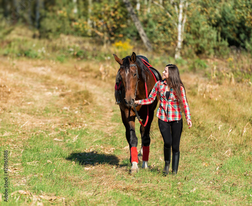 beautiful long hair young woman with horse outdoor