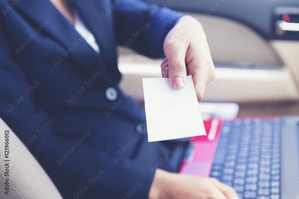 Business woman handing a business card in the car.She showing an Business woman handing a business card in the car.She showing an