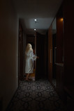 Barefoot Woman with white Bathrobe open the Door