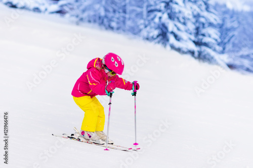 Little girl skiing in the mountains