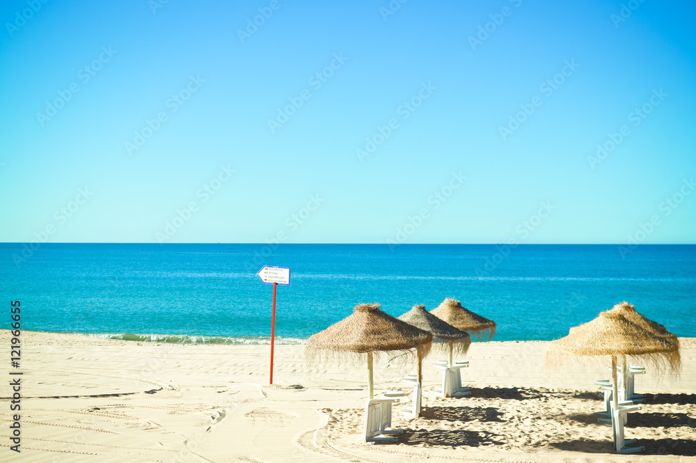 Beach ready for tourists. Golden sand with blue sky outdoors nature background Beach ready for tourists. Golden sand with blue sky outdoors nature background