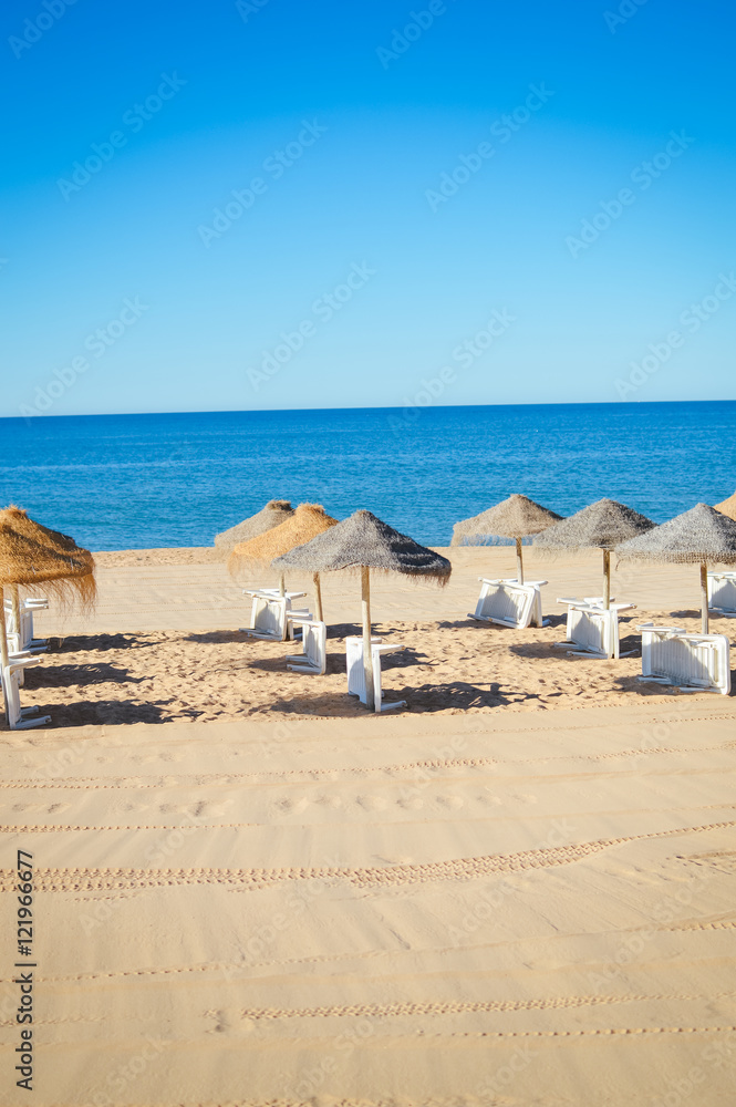 Beach ready for tourists. Golden sand with blue sky outdoors nature background