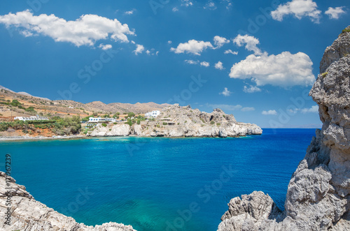 Agios Pavlos Beach in Crete island, Greece. Tourists relax and bath in crystal clear water of St. Paul Sandhill Beach.