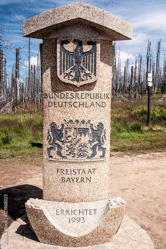 german side of border stone on Dreieckmark in Bavariant Forest with coat of arms of Germany and Bavaria photo