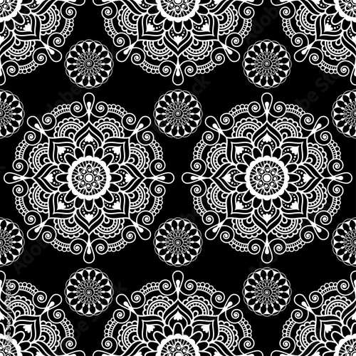Seamless pattern mandala mehndi floral lace elements of buta decoration items on black background.