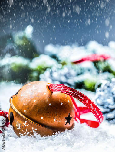 Christmas balls jingle bells. Red  ribbon with text Happy Christmas. Snowy abstract background and decoration. photo