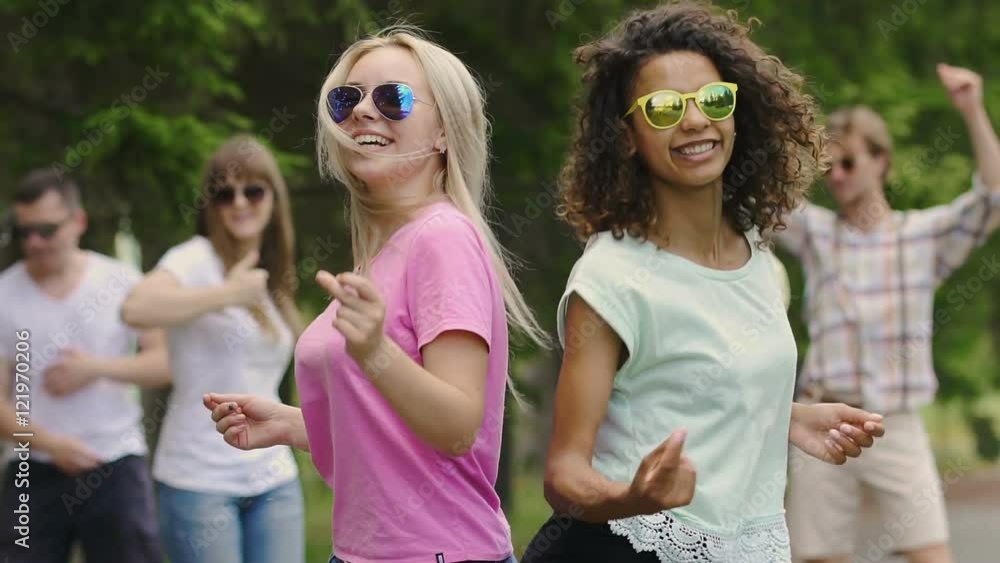 Happy cheerful young people dancing like crazy at music festival, emotions, fun Happy cheerful young people dancing like crazy at music festival, emotions, fun