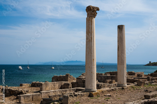 A couple of Corinthian columns overlooking the sea at the archaeological site of Tharros (Sardinia, Italy) photo