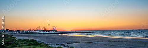 Sunrise on Galveston beach with pier photo