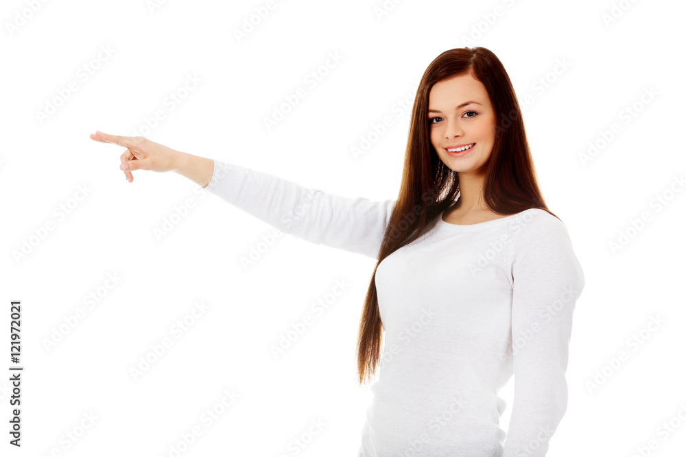 Smiling young woman shows something Smiling young woman shows something