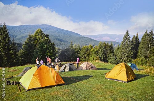 Mountain landscape at sunshine. Tourist tents in forest   Carpathian  Ukraine 