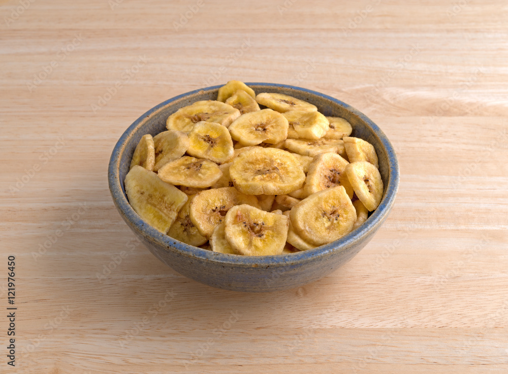 Dried bananas in an old bowl on a table Dried bananas in an old bowl on a table