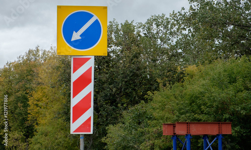 Road sign on the forest background