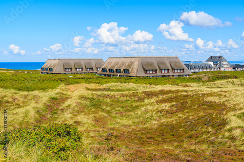 View of typical houses with straw roofs in Kampen village on western coast of Sylt island, Germany photo