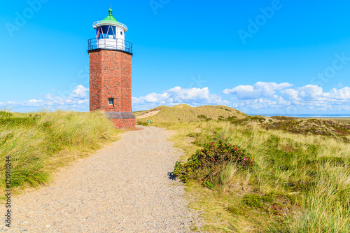 Lighthouse on sand dune against blue sky with white clouds on northern coast of Sylt island near Kampen village  Germany