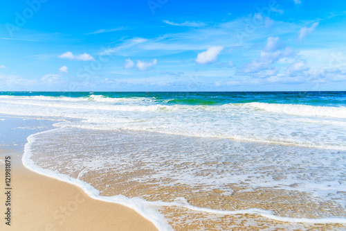 Sea waves on beautiful sandy beach on sunny summer day  Sylt island  Germany