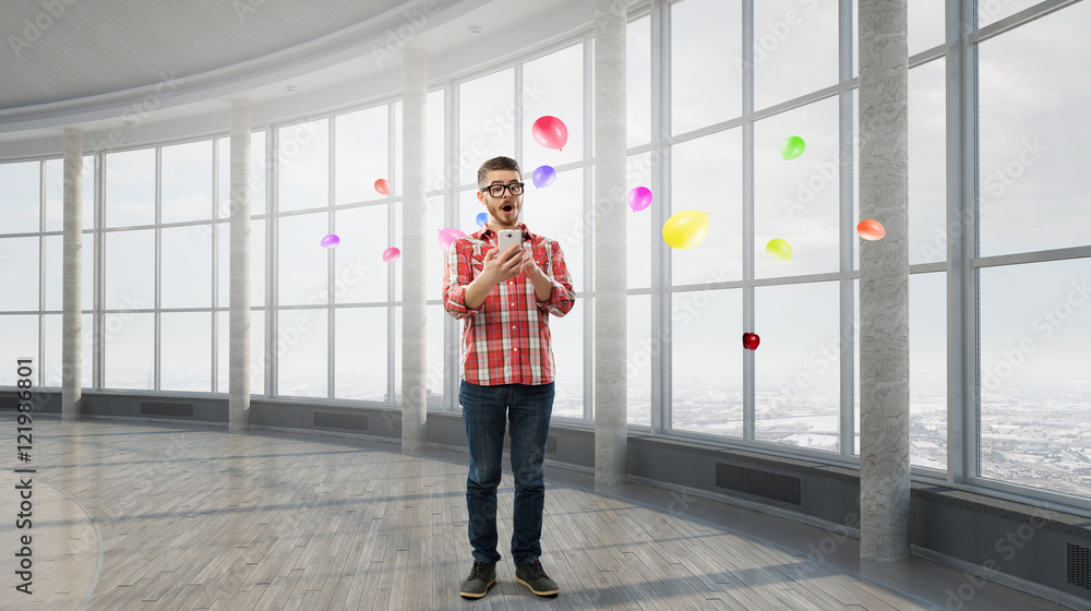 Fototapeta premium Hipster guy use his smartphone . Mixed media