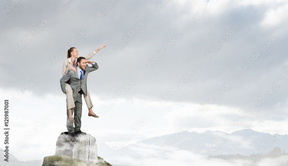 Businesswoman riding colleague back . Mixed media Businesswoman riding colleague back . Mixed media