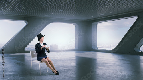 Businesswoman on chair in office . Mixed media