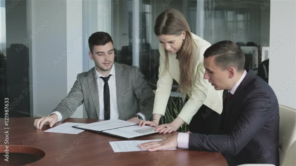 Team leader woman in yellow jacket is talking with a colleagues at a meeting room. Team leader woman in yellow jacket is talking with a colleagues at a meeting room.