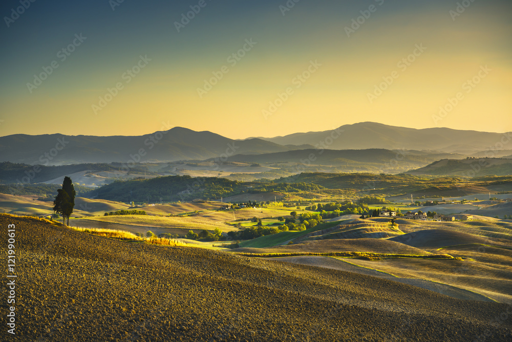 Fototapeta premium Tuscany Maremma sunset. Trees, farmlands, hills and fields. Ital