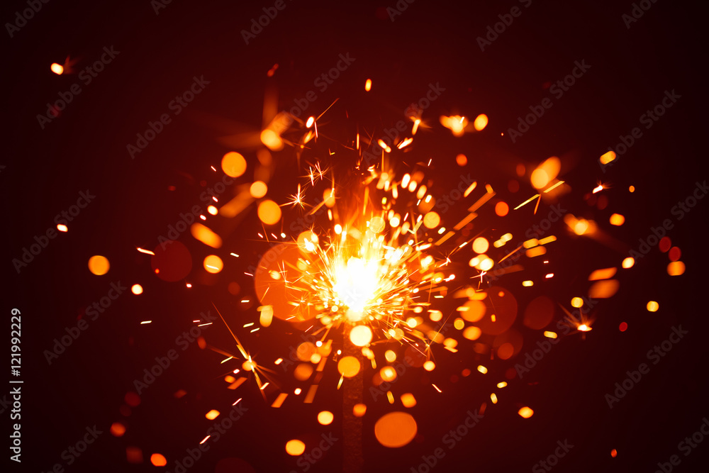 Obraz premium Christmas sparkler in haze with red light