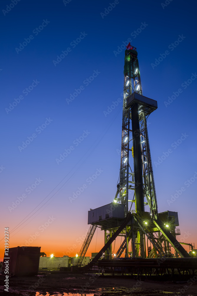 oilfield derrick at night