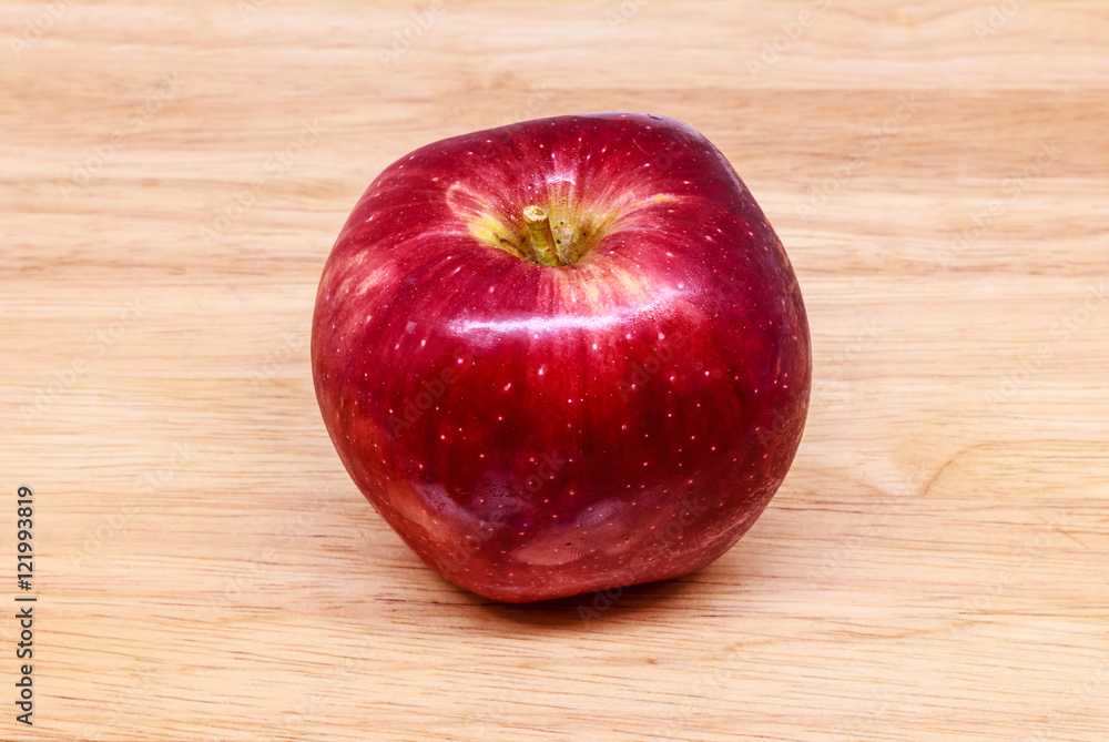 Fresh red apple on wood background.