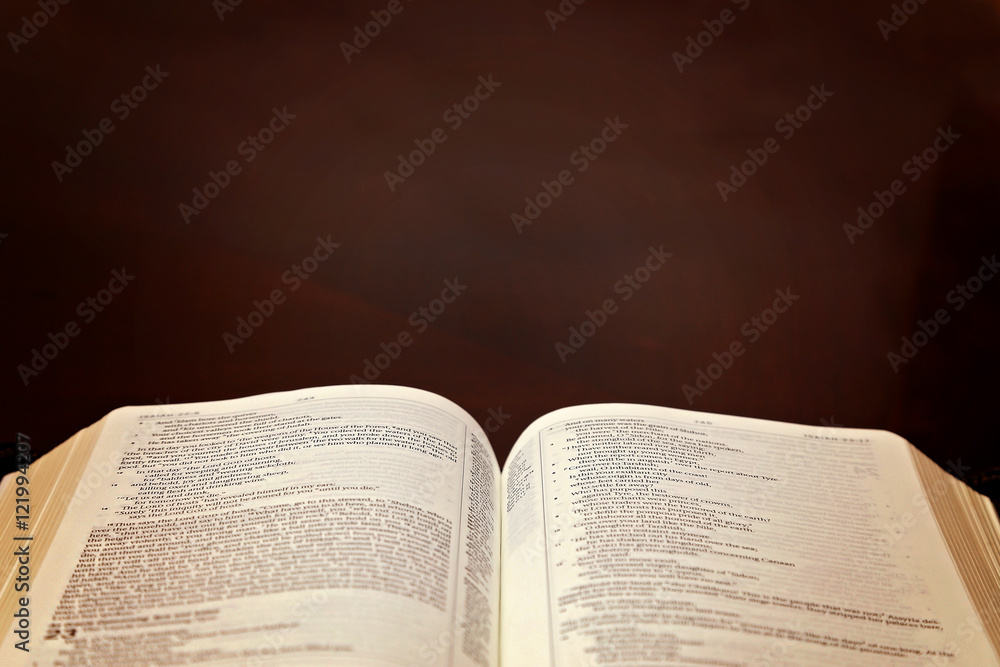 Fototapeta premium Holy Bible Open on a Wooden Table