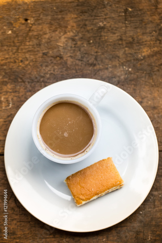 Coffee cup with sweets on the table brown.