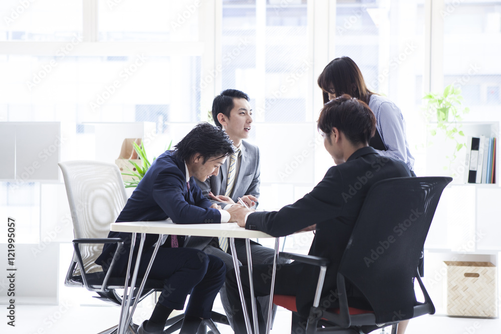 Four business people are meeting in a stylish office Four business people are meeting in a stylish office