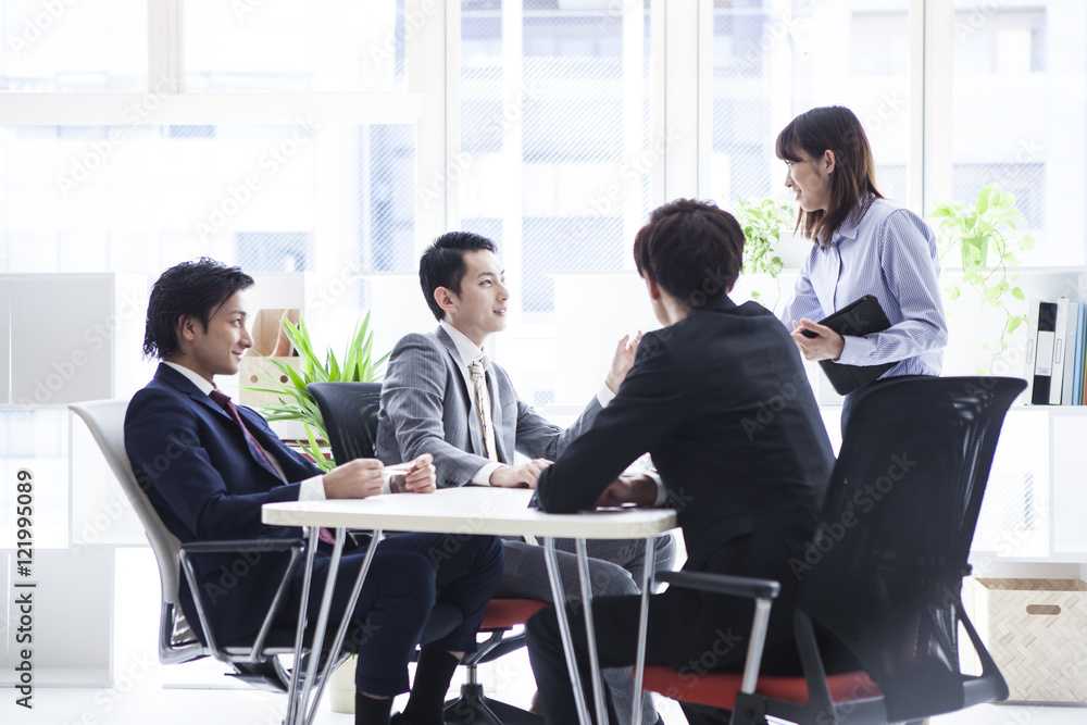 Four business people are meeting in a stylish office Four business people are meeting in a stylish office